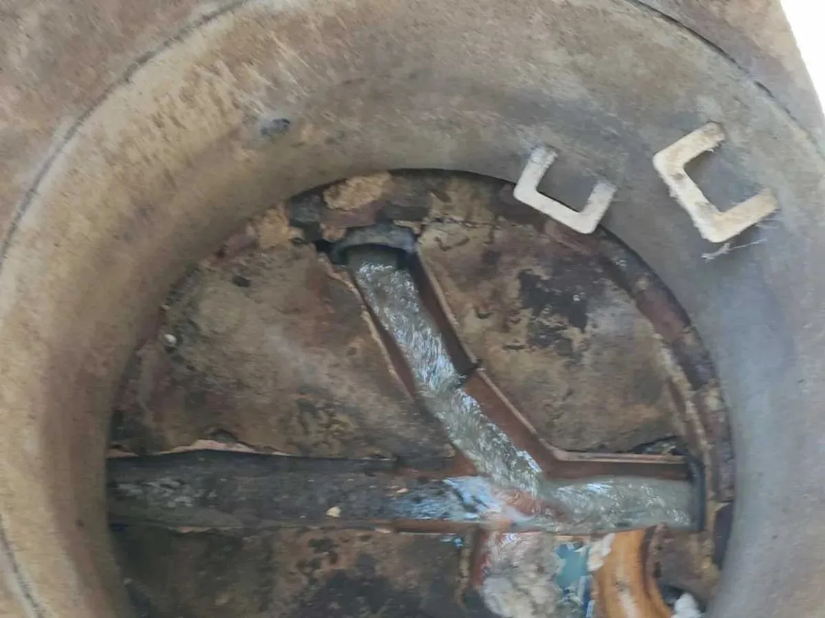 Looking down into a drain chamber with clean water flowing through the channels